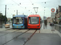 Mìstská tramvaj (v modrém nátìru) a pøímìstká tramvaj (èervená) pøed nádražím v Chemnitz 14.8.2005
