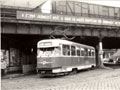 Vůz T2 č. 153 u nádraží s pěkným dobovým nápisem na mostě 4. 4. 1987, 
foto: Tomáš Palyza 