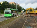 Autobus náhradní dopravy projíždí kolem výkopu a zastávky Malesická 15. 8. 2011